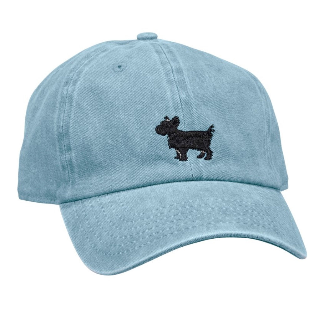A blue baseball cap with the outline of a yorkie on the front