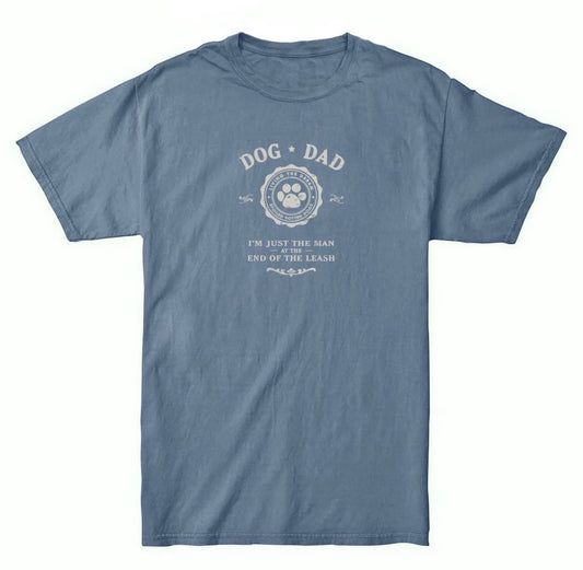 A bluejean colored tshirt that reads Dog Dad "I'm just the man at the end of the leash"