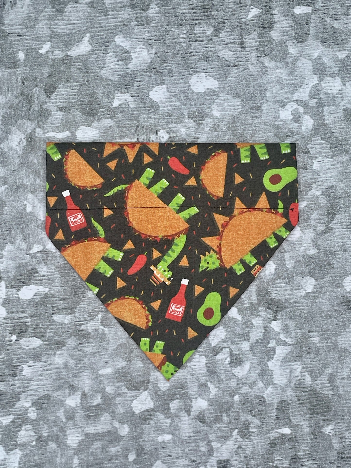 a black dog bandana with a Taco dinosaur