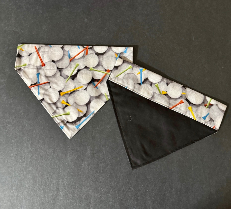 a dog bandanna with golf balls and tees