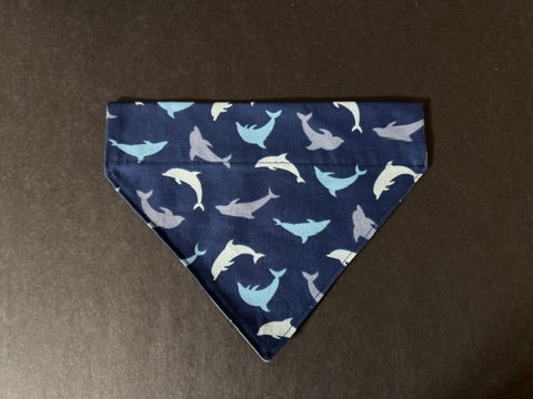 a navy dog bandanna with outlines of dolphins