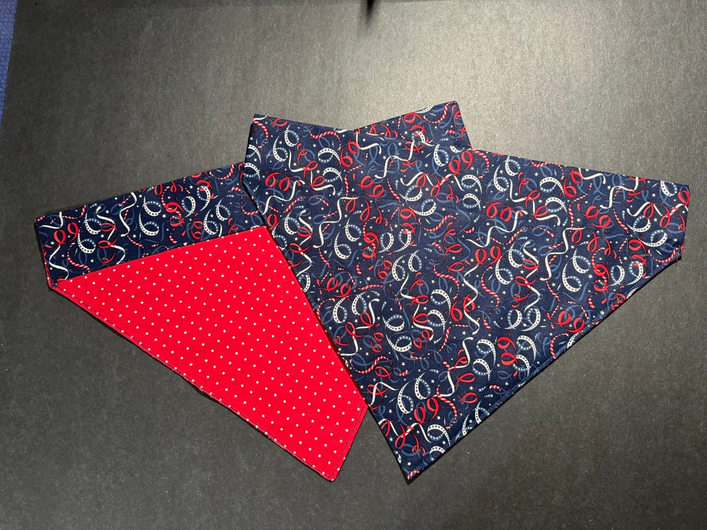 a patriotic dog bandanna with a navy background and red and white streamers