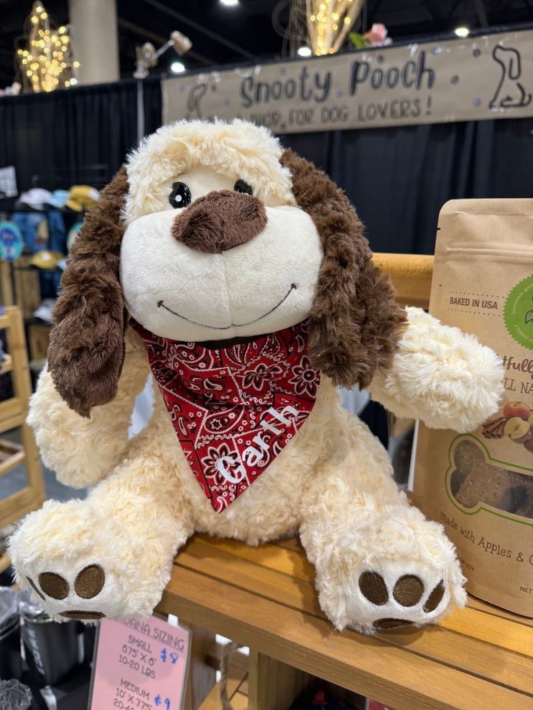 a red paisley dog bandana on a stuffed dog