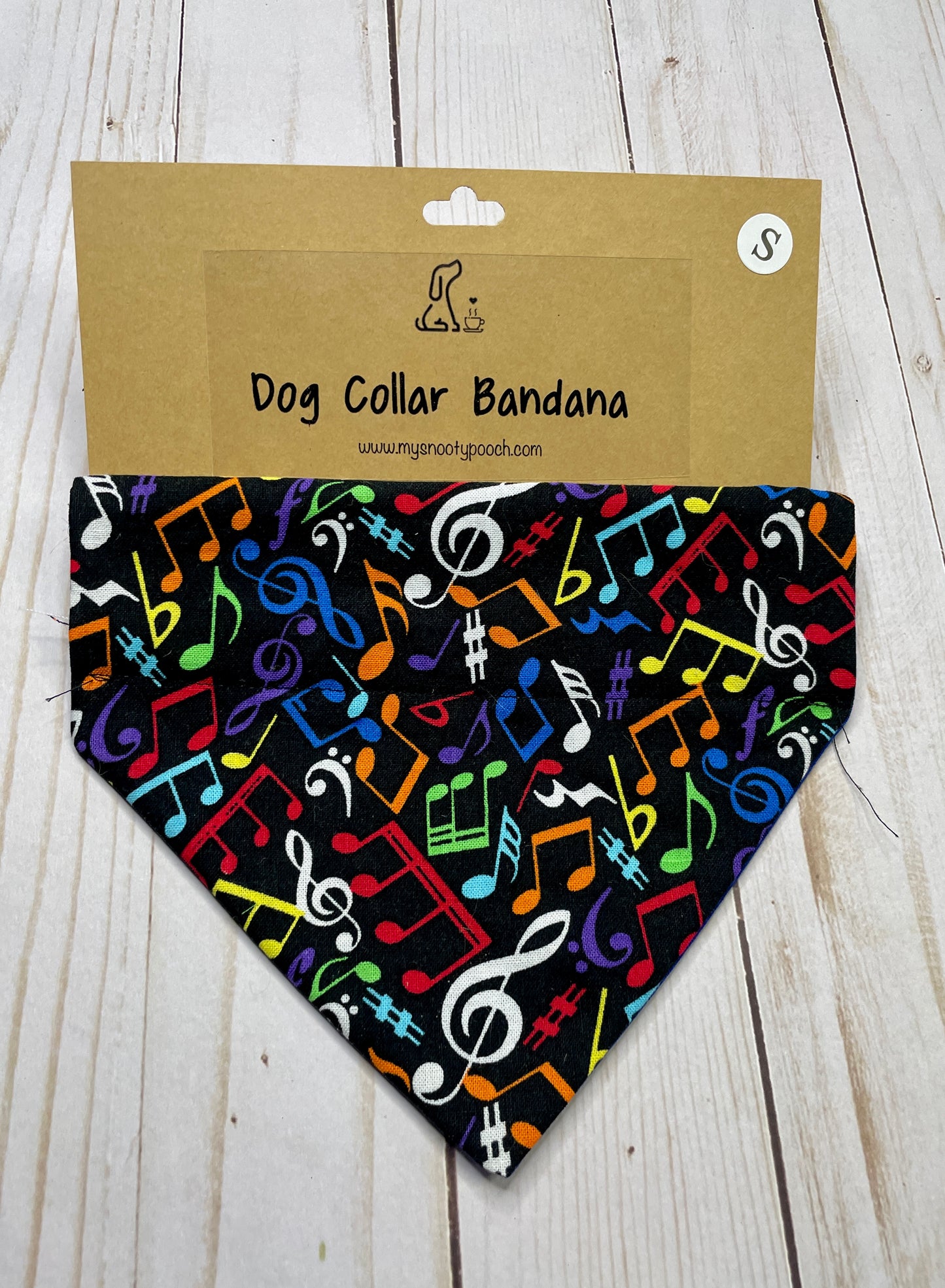 a black dog bandanna with colorful music notes