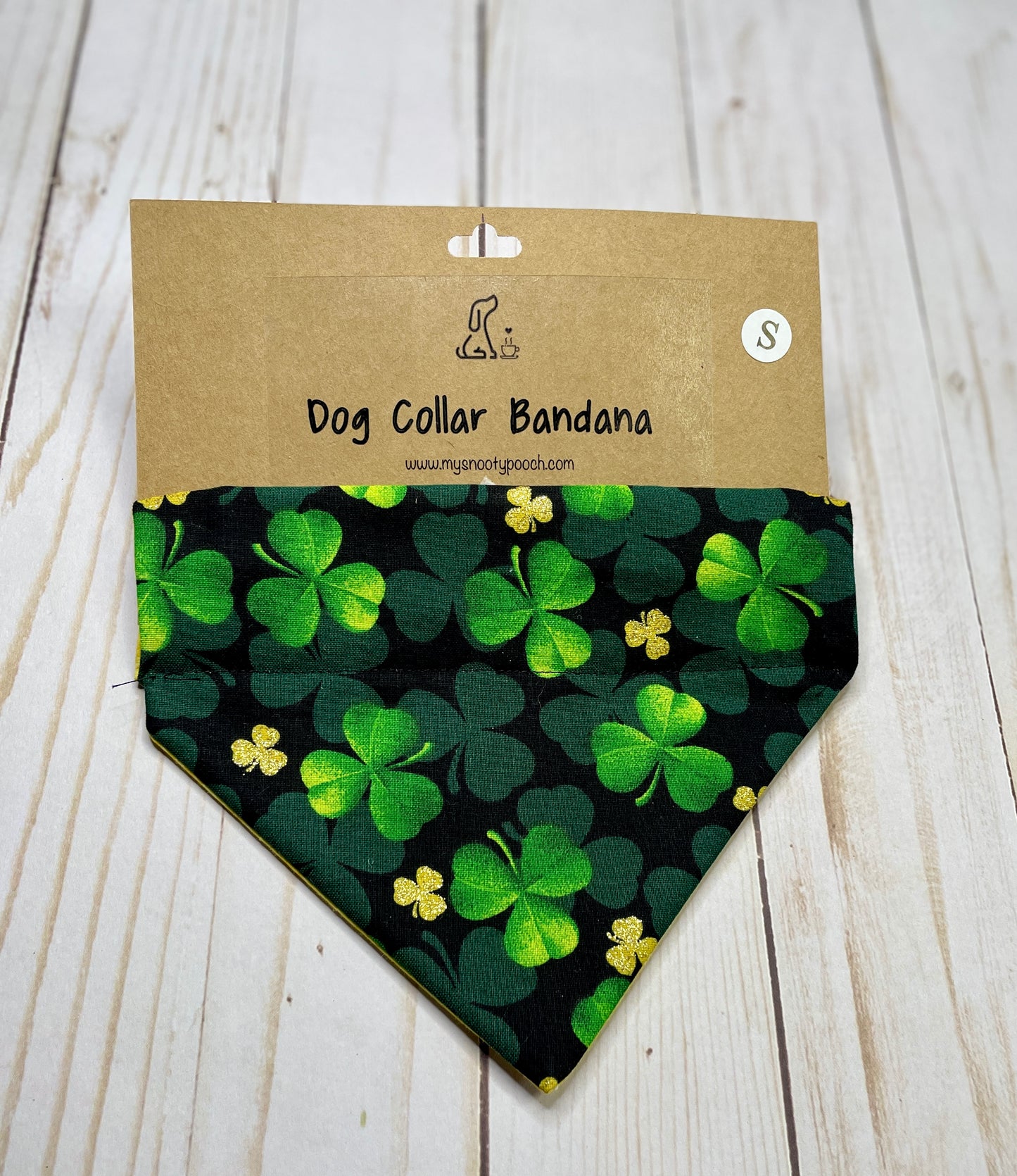 a black dog bandanna with green and gold clovers on it