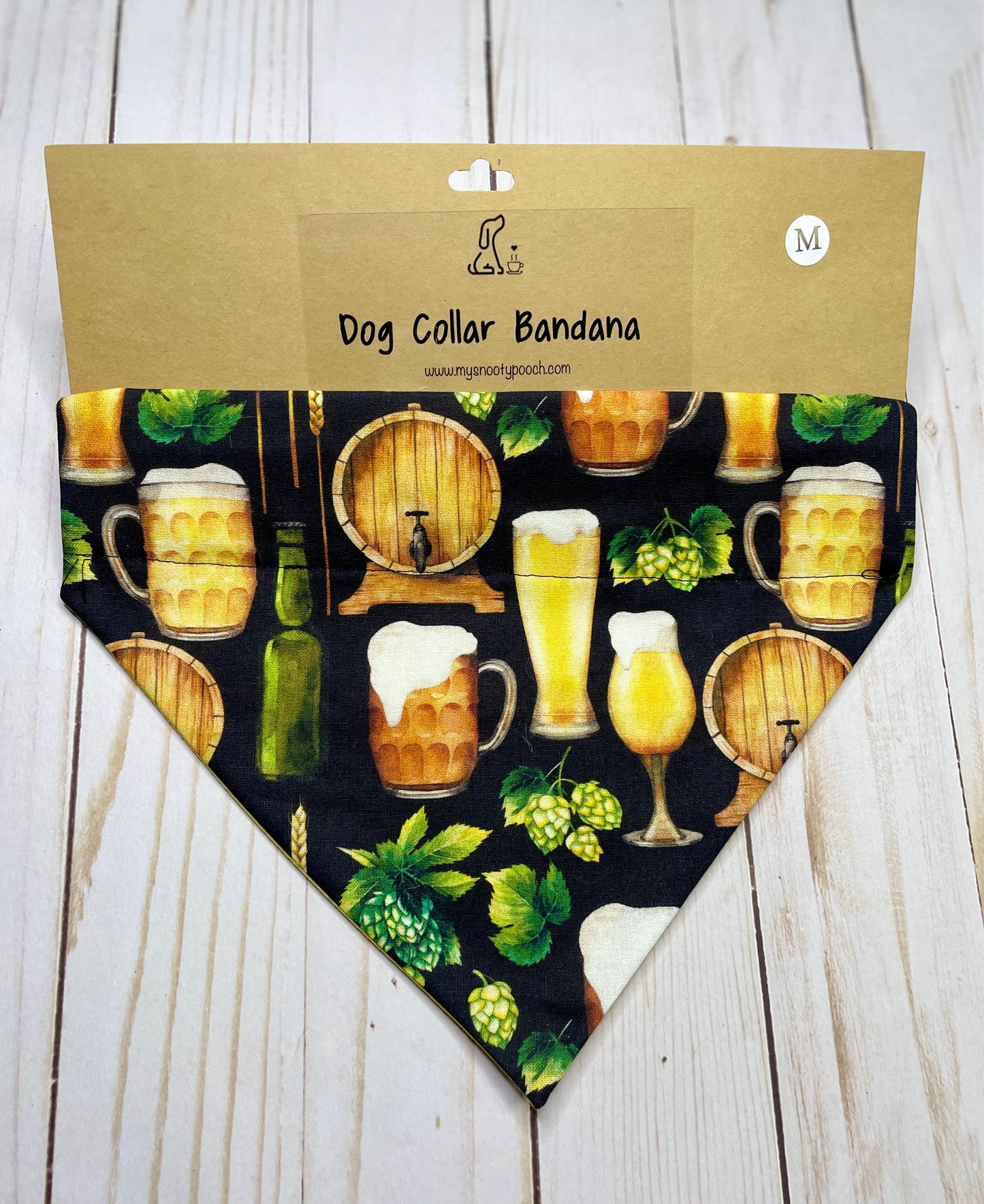 a dog bandanna with a black background with a beer keg, beer glasses, and hops