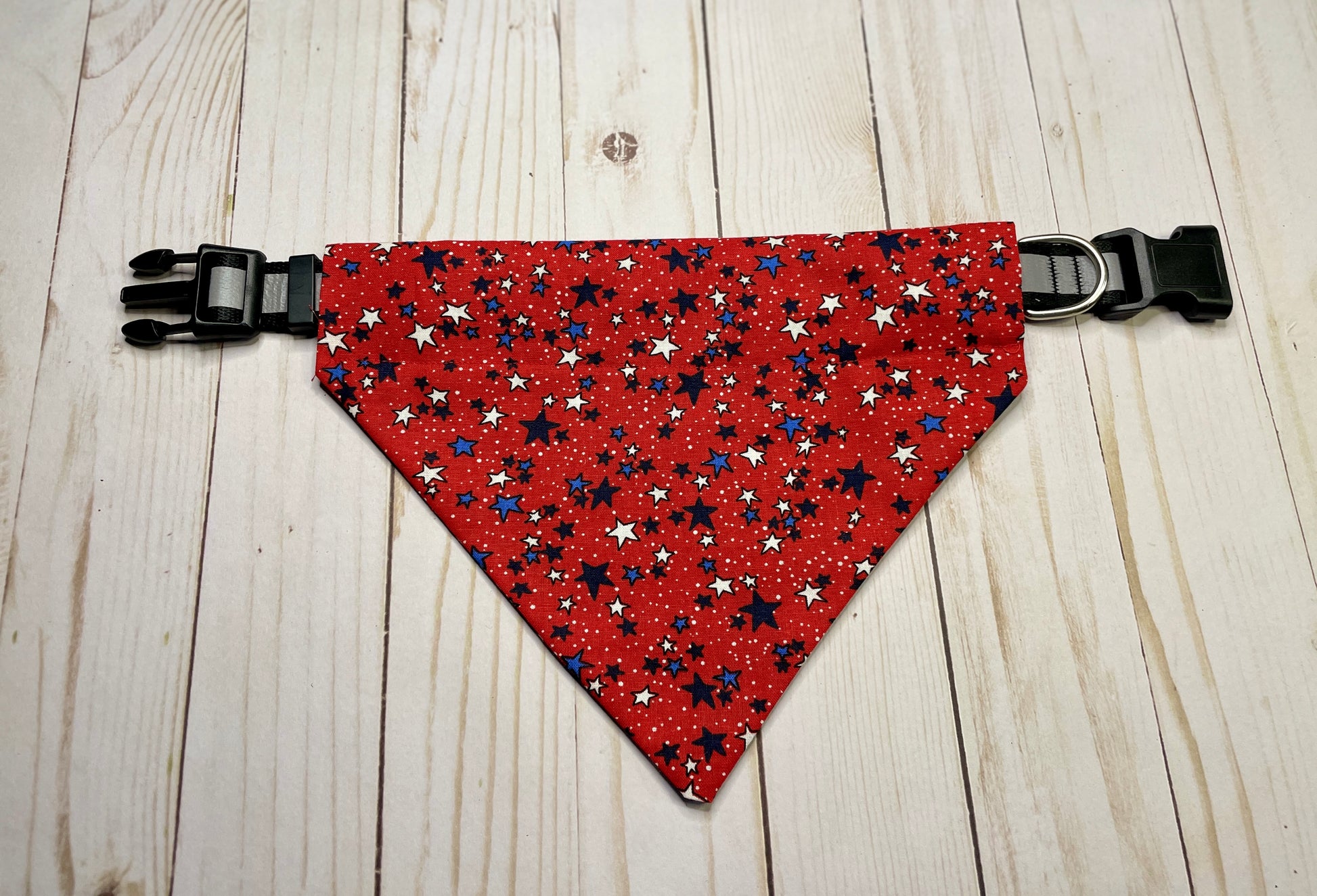 a dog collar bandana that is red, white, blue, and black stars
