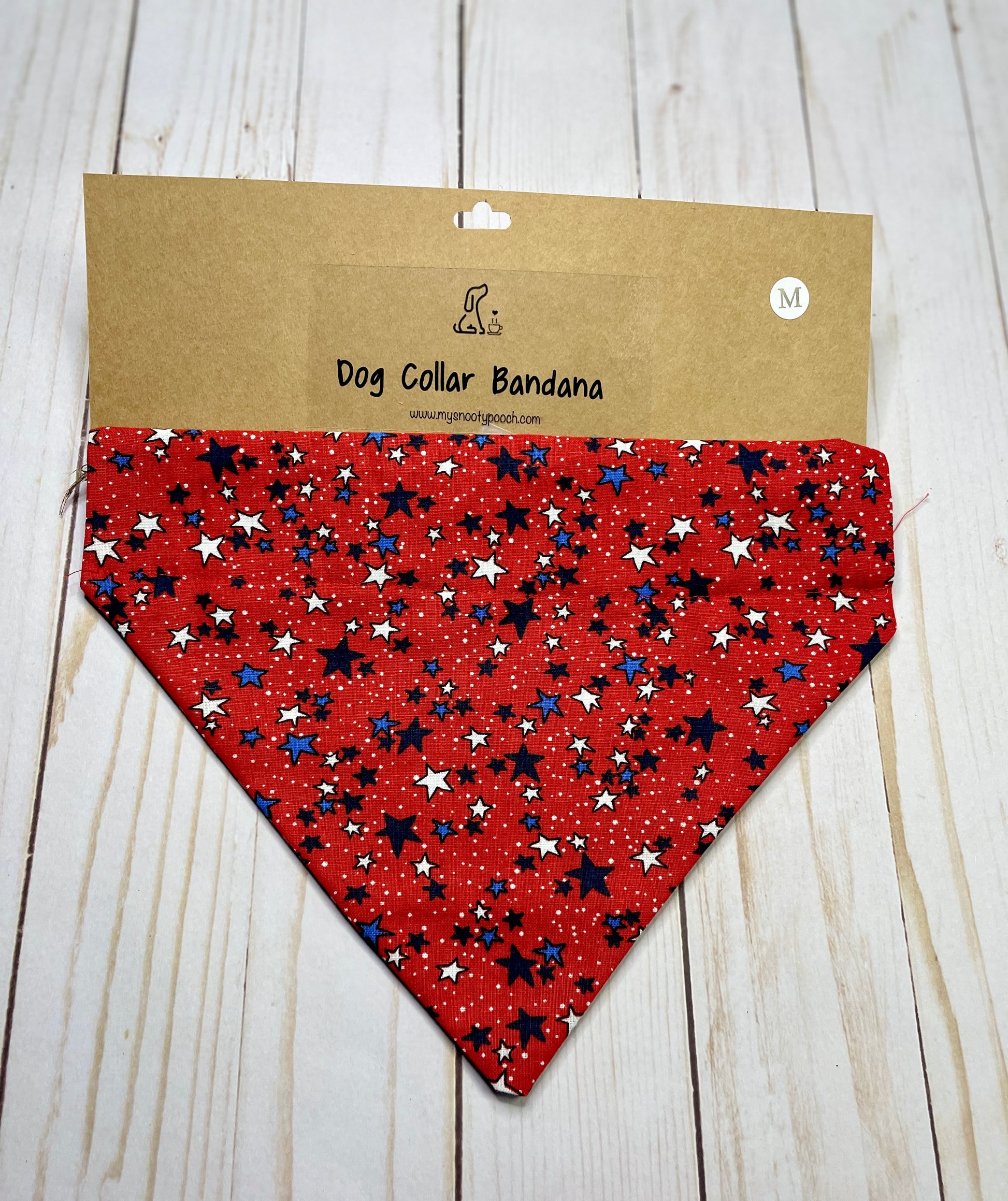 a patriotic dog bandana with a red background and white & blue stars
