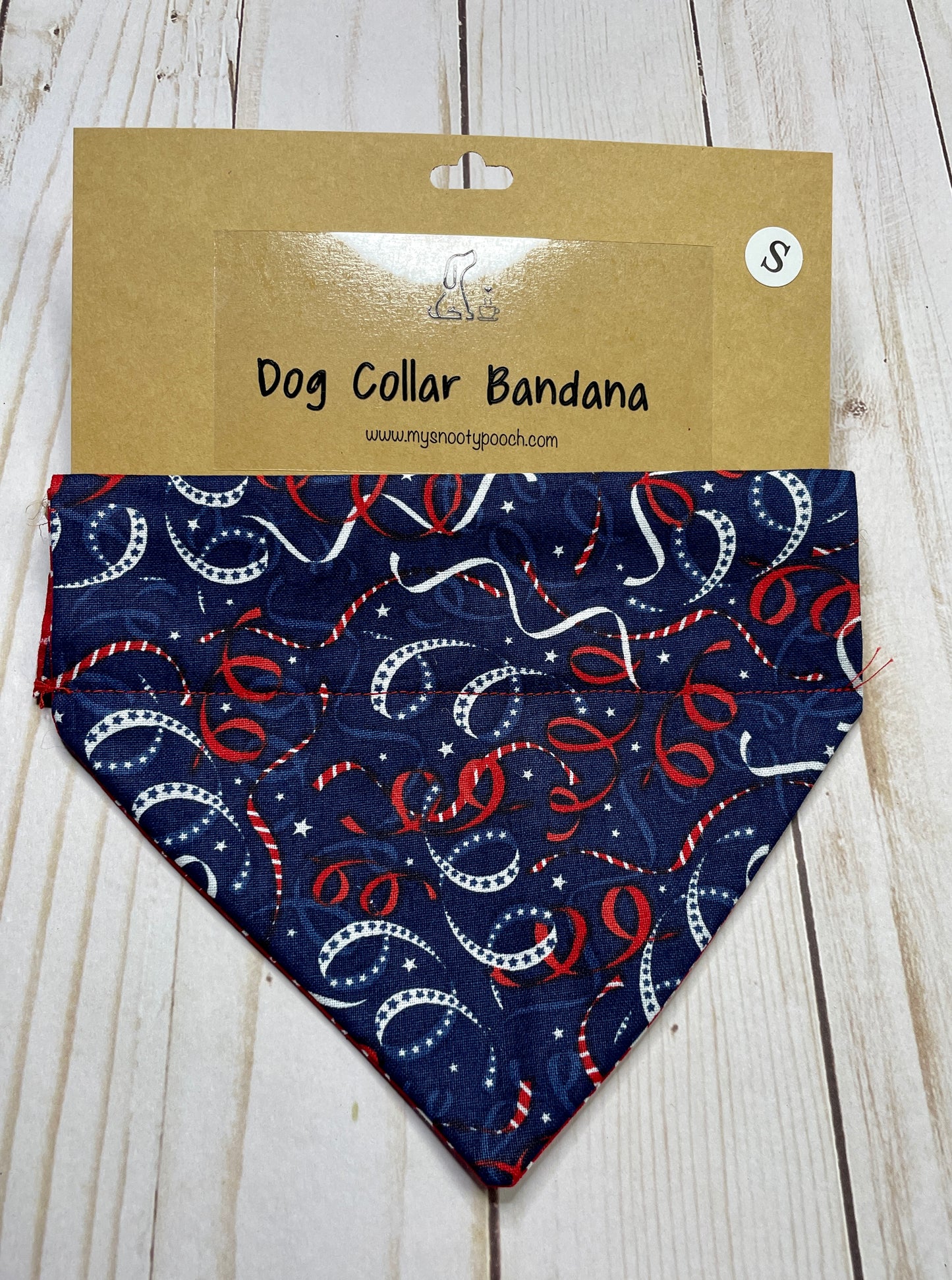 a patriotic dog bandanna with a navy background and red & white streamers