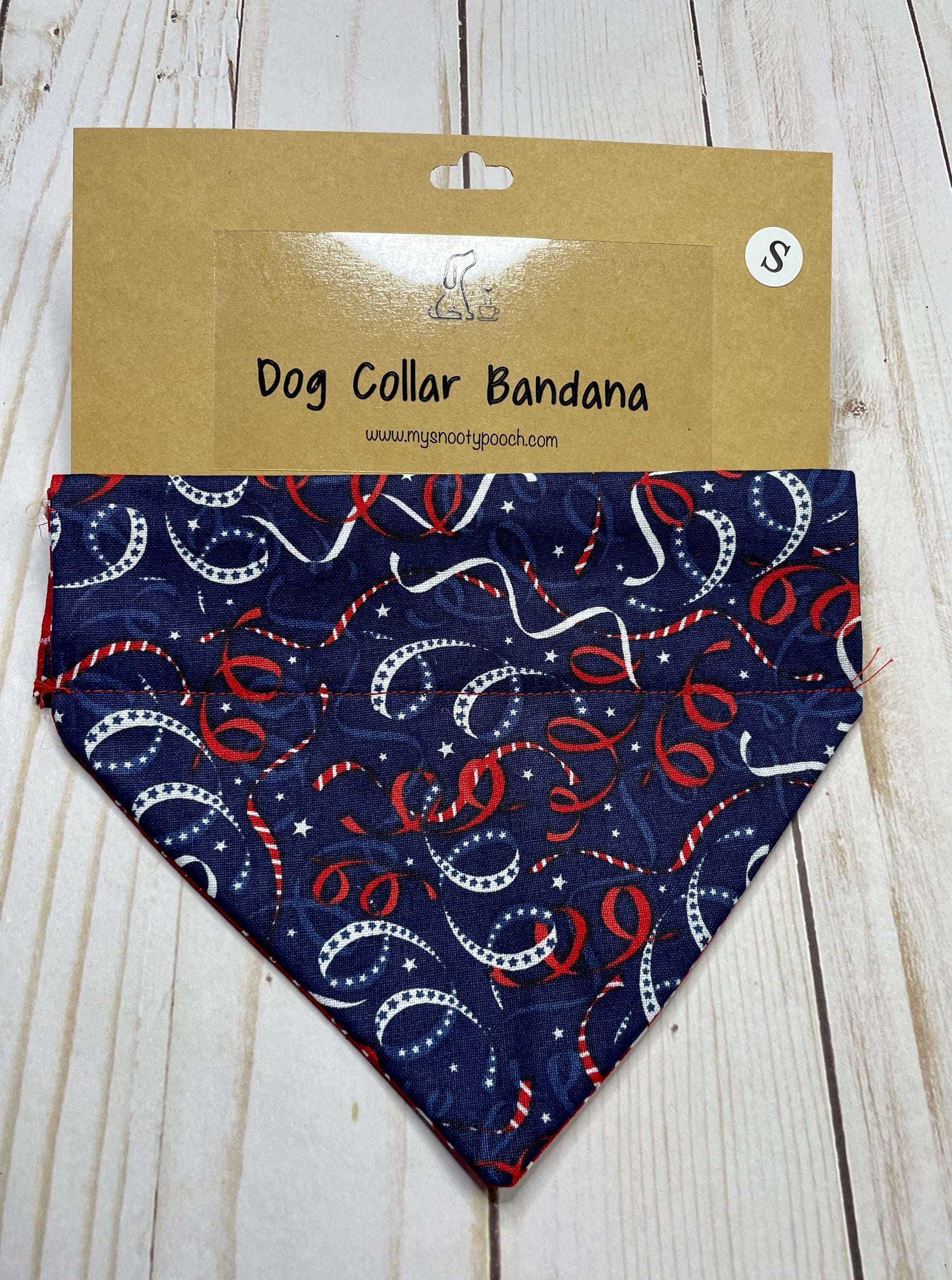 a patriotic dog bandanna with a navy background and red & white streamers